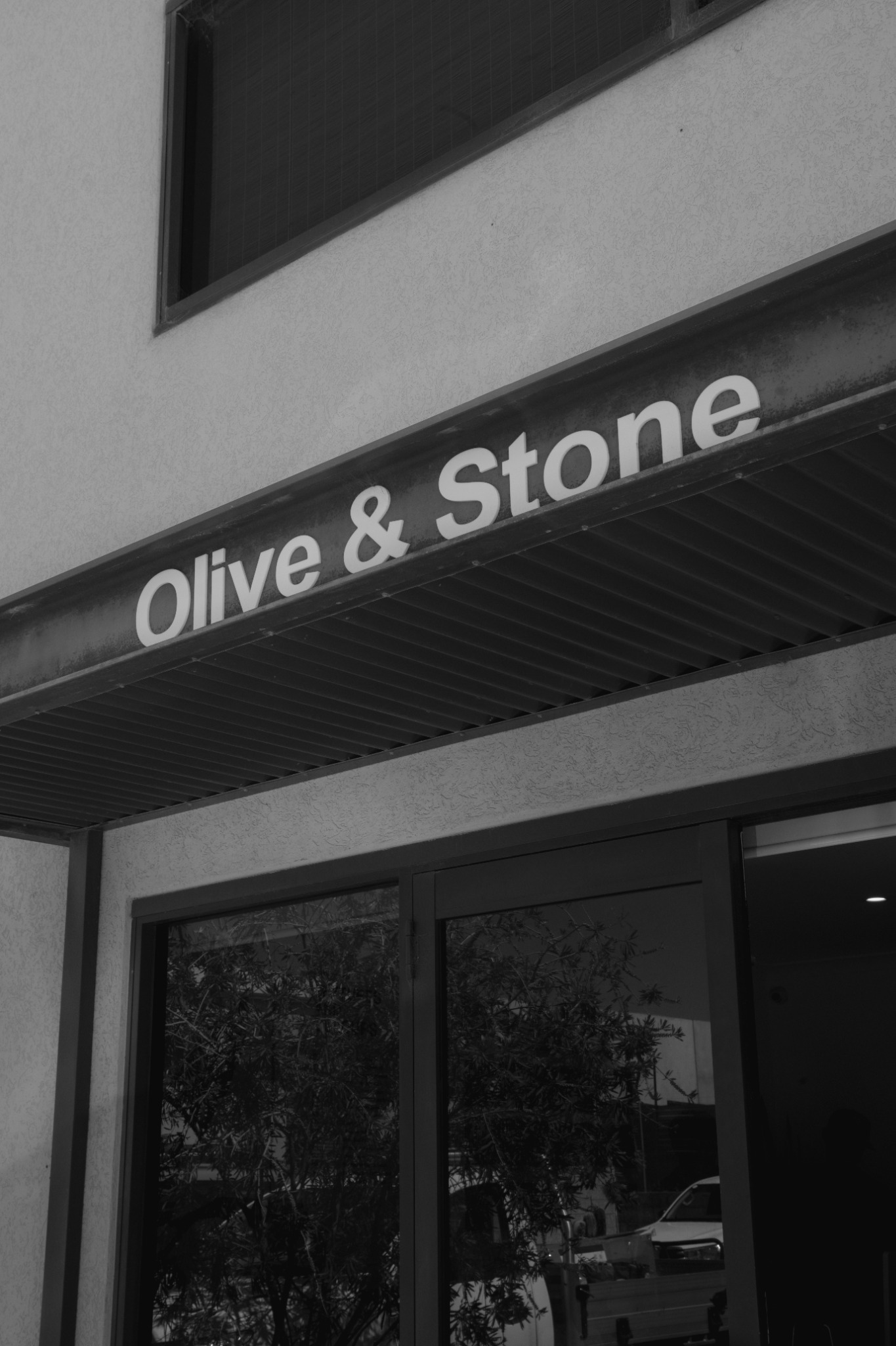 The Olive & Stone sign above our Landsdale studio entrance