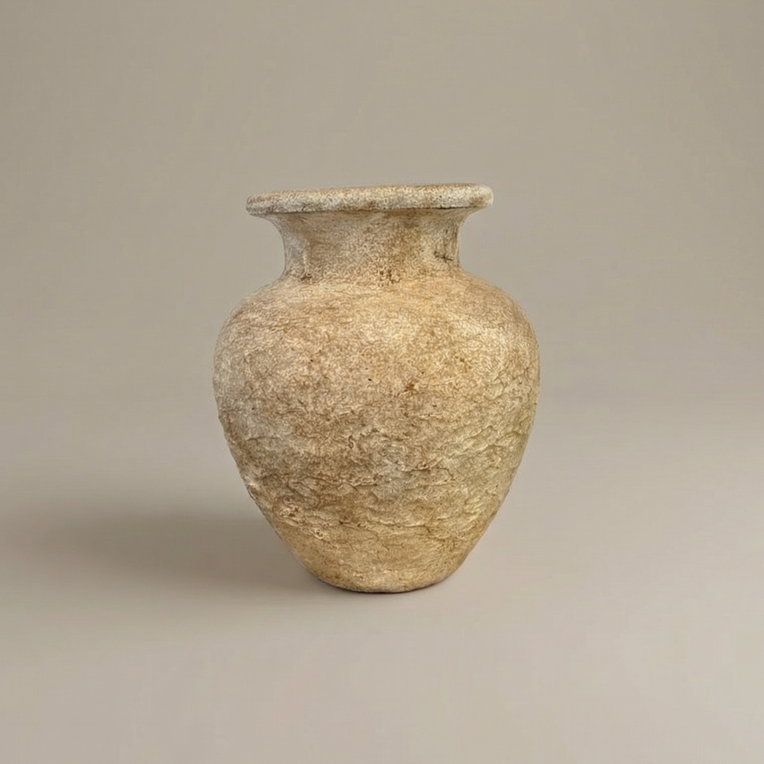 Textured ceramic vase on a beige background