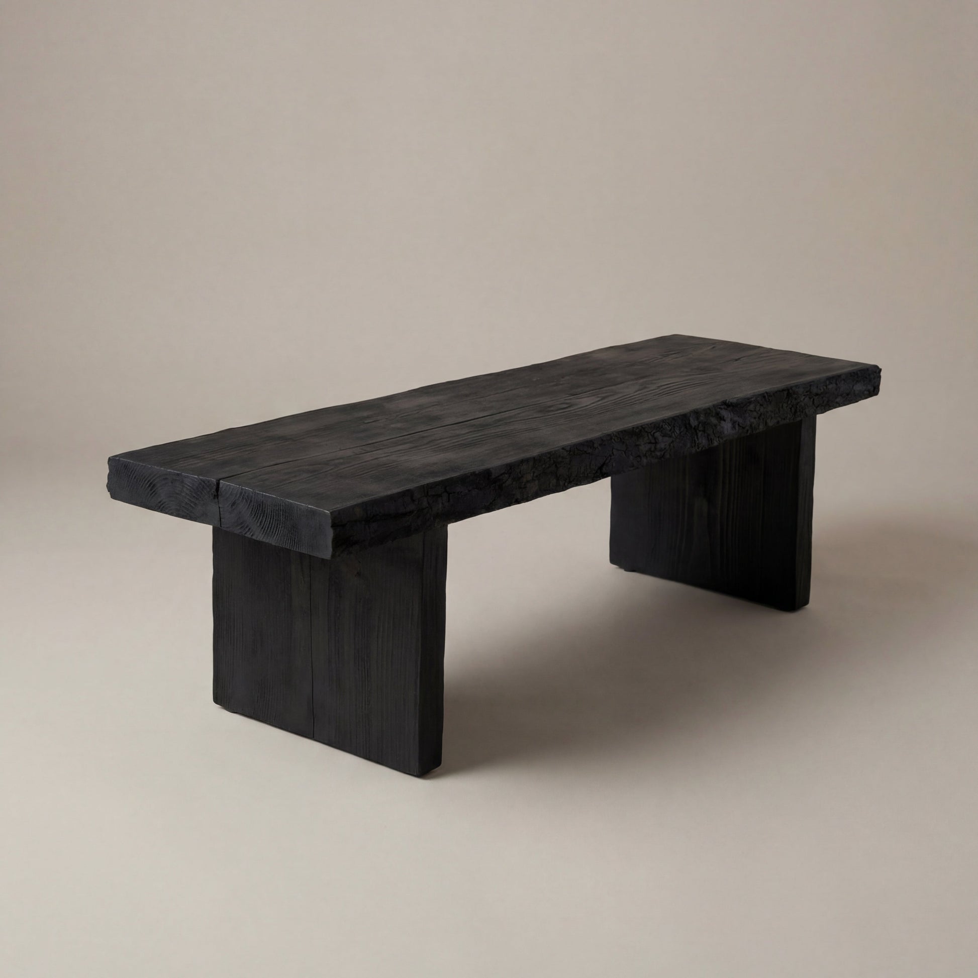 Black wooden bench on a beige background