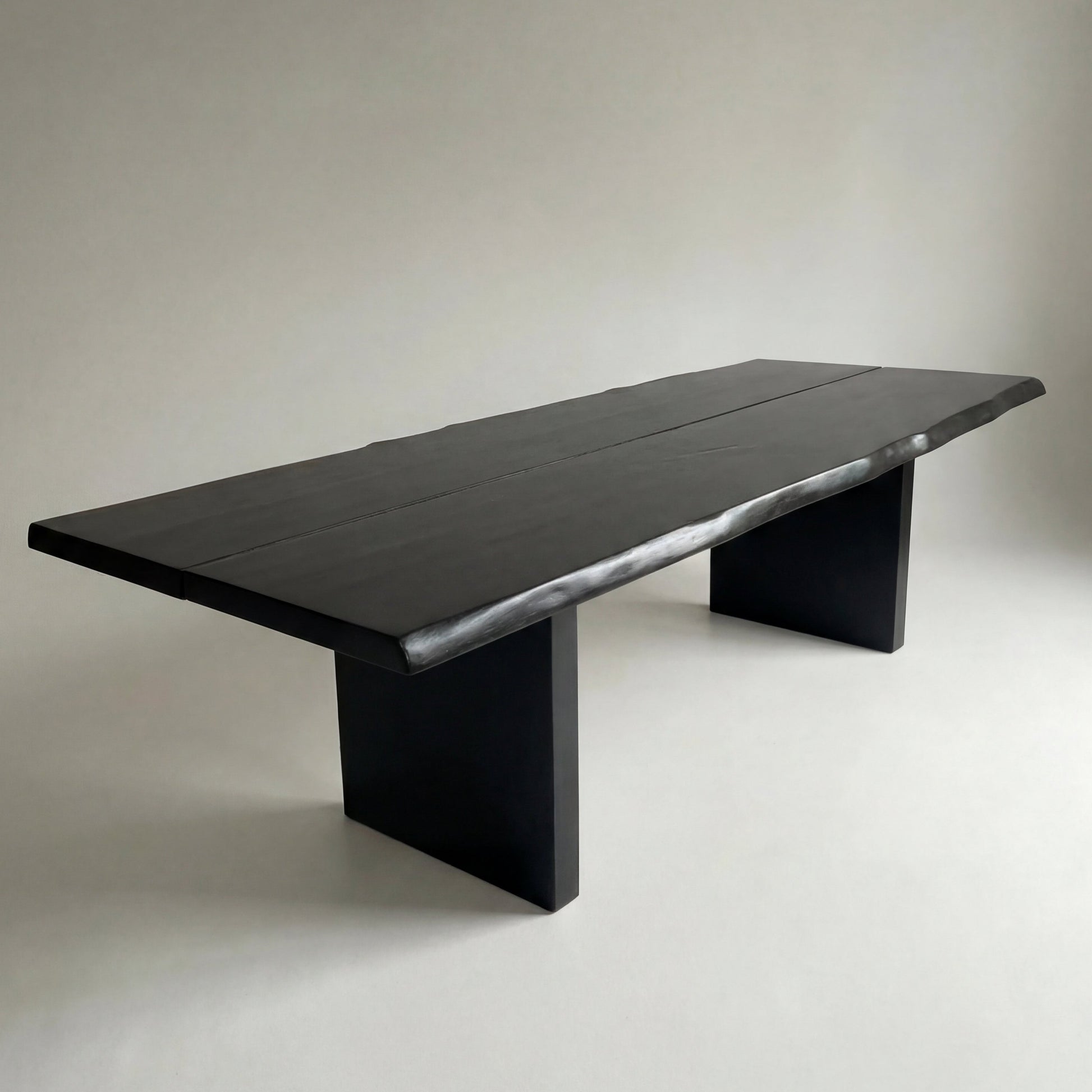 Modern black dining table on a plain background
