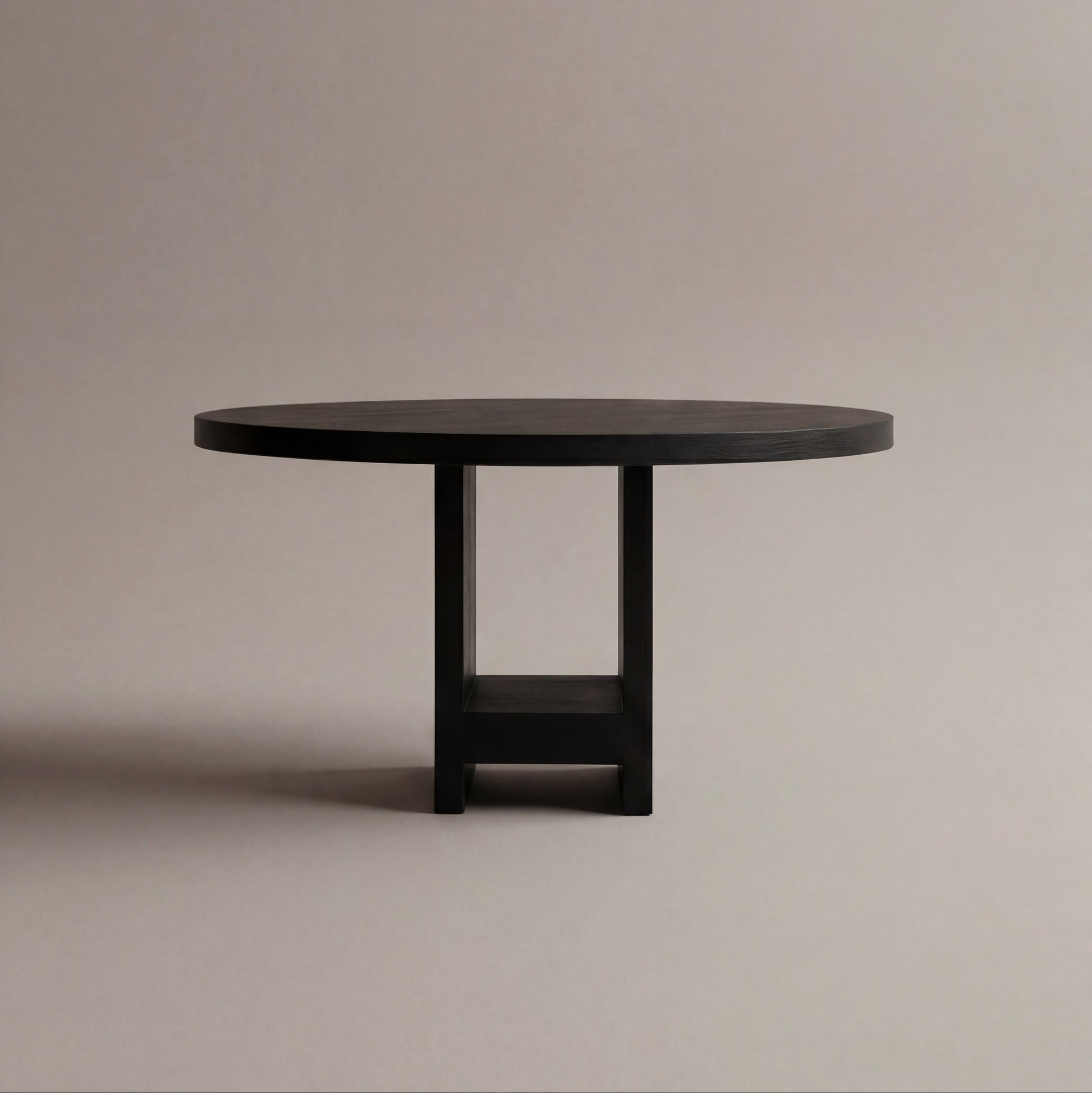 Black round table on a beige background